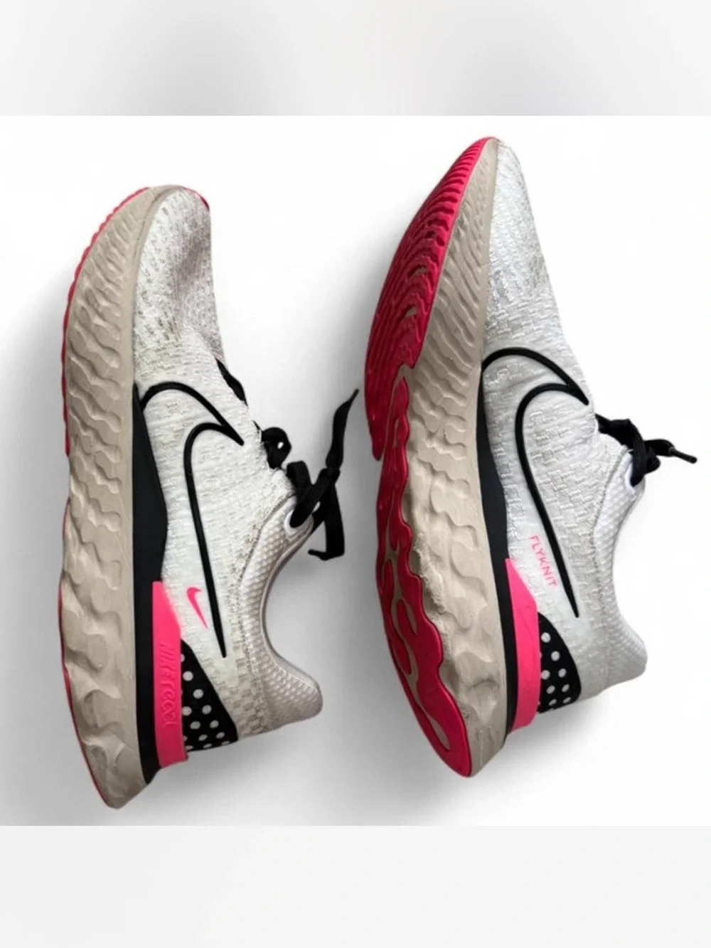 Nike Men’s White Flyknit Running Shoe with Pink Accents